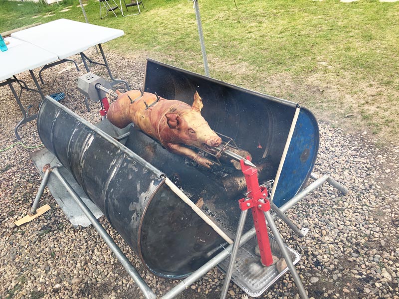 A charcoal rotisserie surrounded by a custom roaster